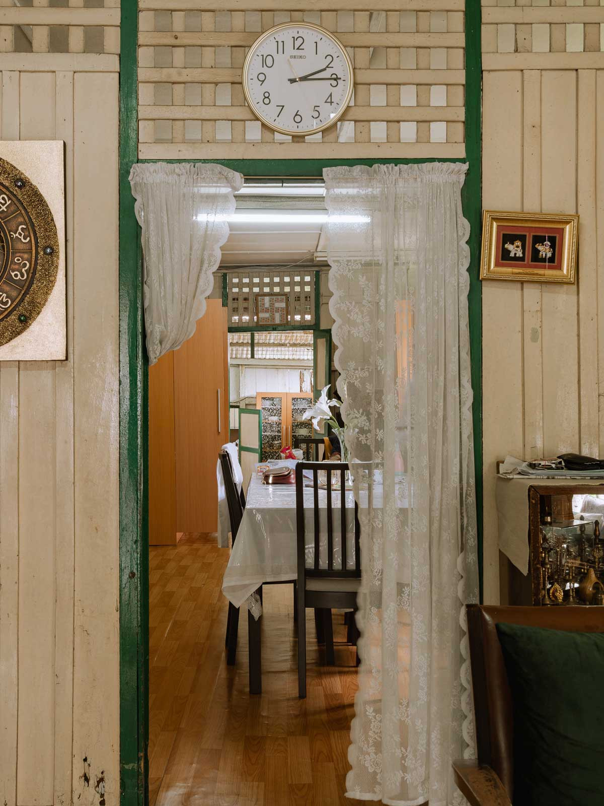 The dining space of the original house before the renovation, defined by a strong ethnic character