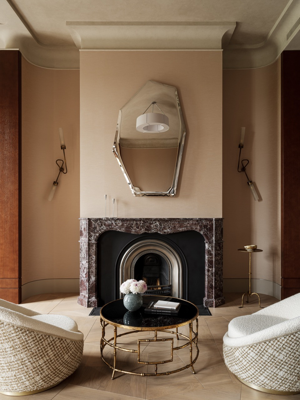 The master bedroom fireplace wall features a Tafla C4 polished stainless steel mirror by Zieta above a Rosso Levante marble mantelpiece with custom lighting