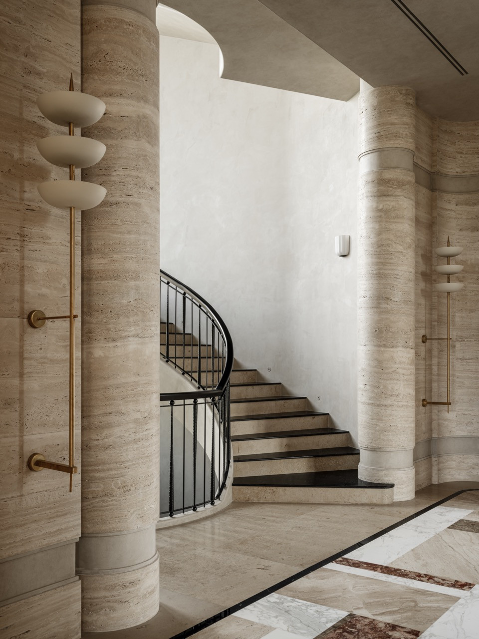 Curved staircase with Nero Marquina marble treads and custom metal railing