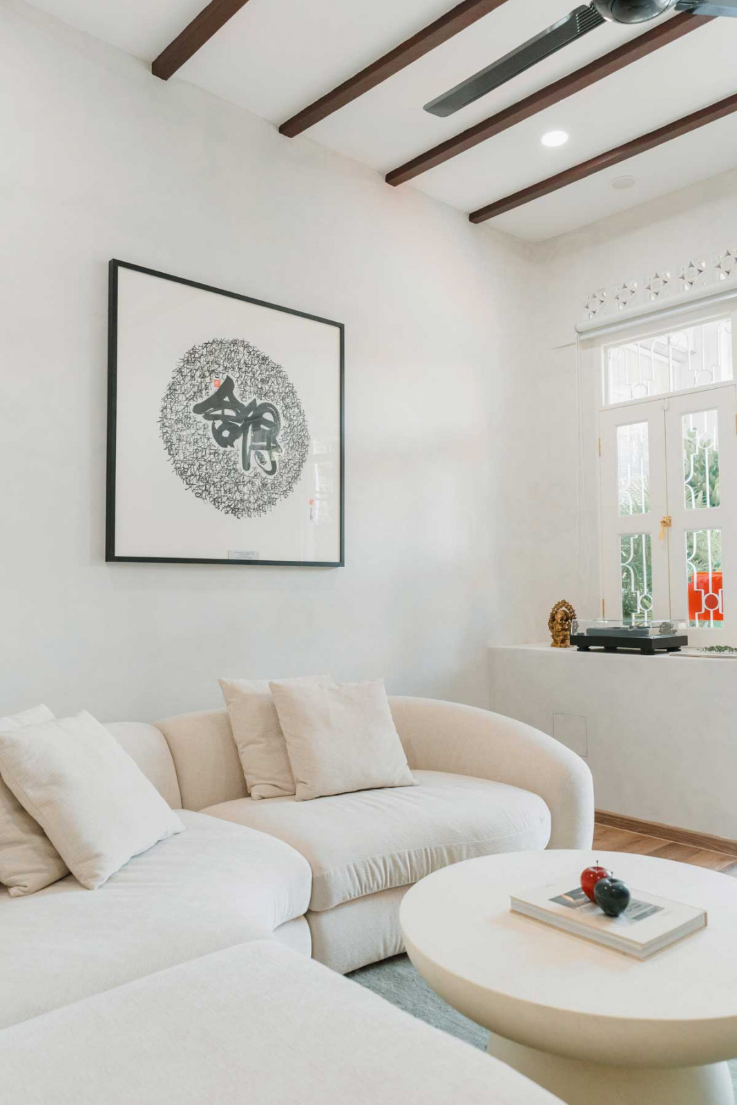 Malaysian artist Jameson Yap’s calligraphy of the Chinese saying “Only by giving can one gain” hangs in the living room