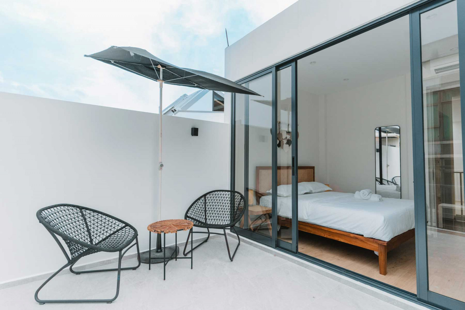 The top-level bedroom opens to an outdoor seating area