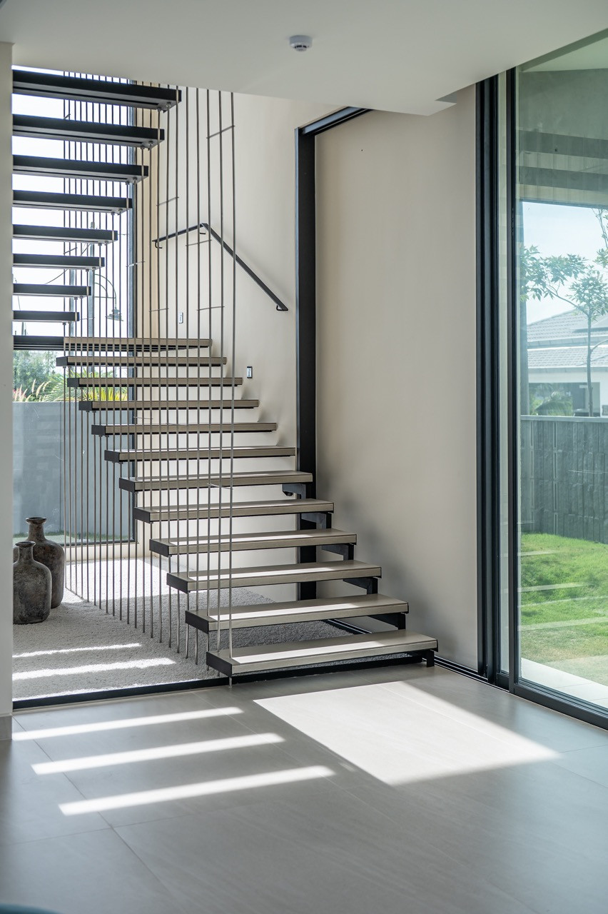 The floating staircase enhances the visual lightness