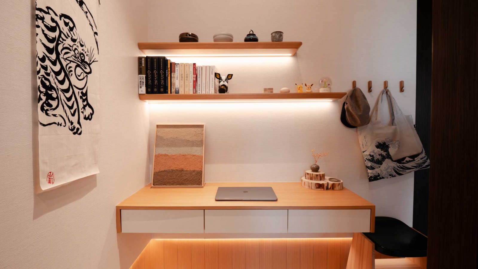 Thoughtful touches like Japanese collectibles, and warm wood tones infuse the workspace with personality and a sense of ritual