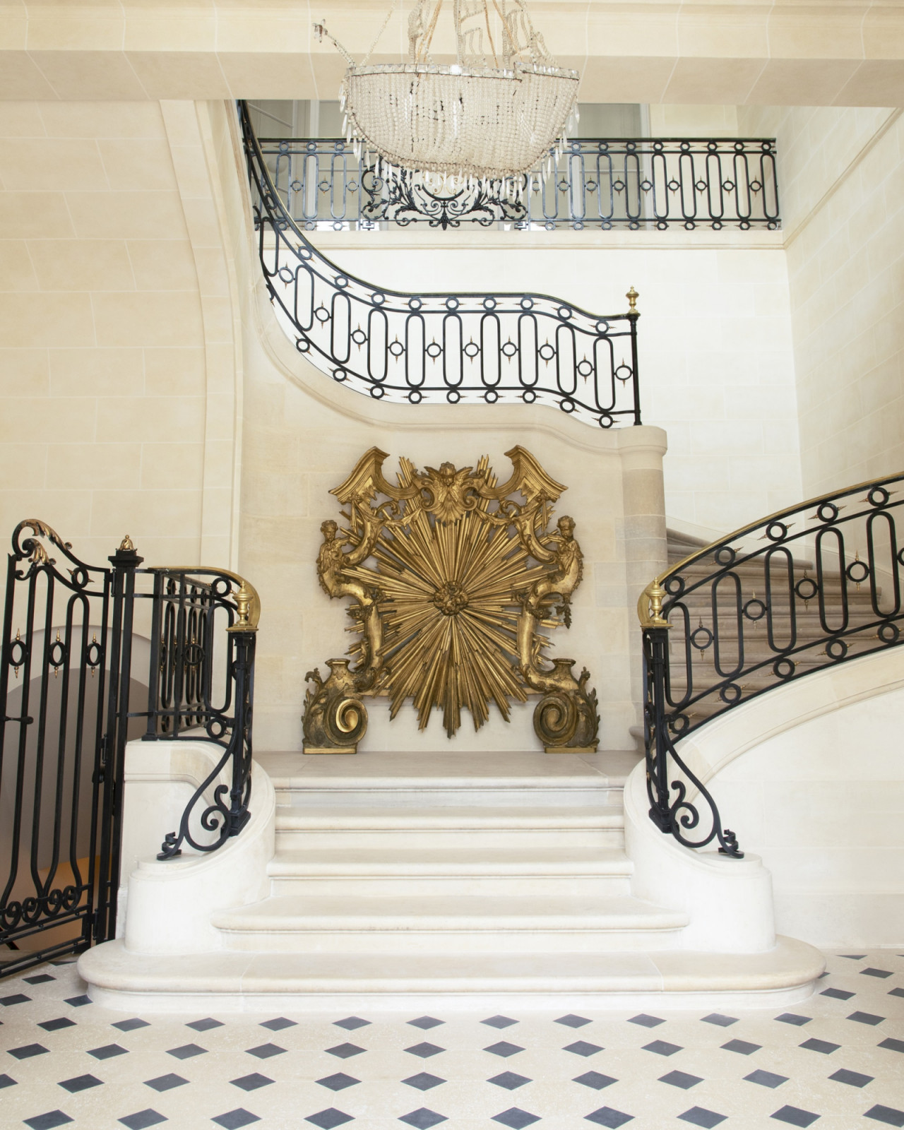 In Maison Vivier's foyer, a grand staircase is accented by a Baroque-era panel. (Photo: Guido Taroni)