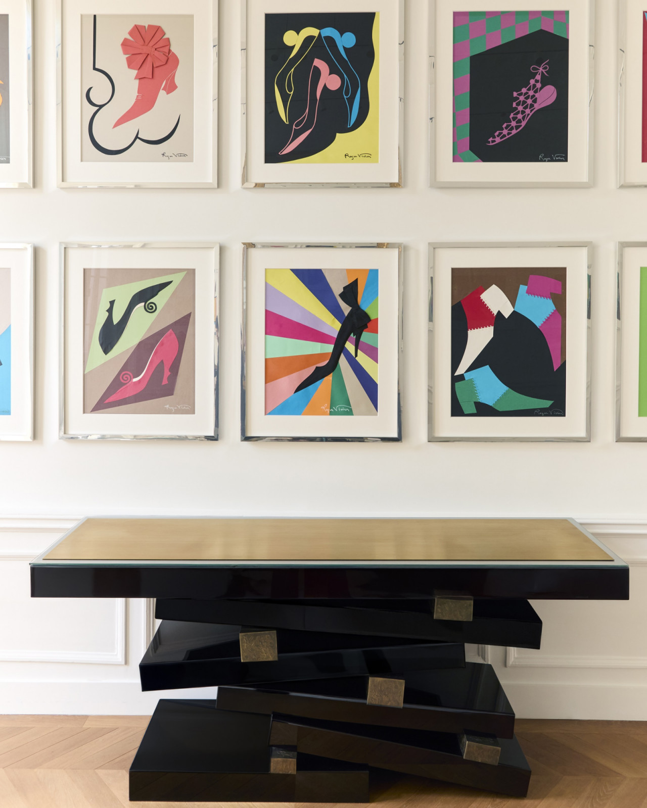 Roger Vivier’s colorful shoe collages hang above a lacquered Herve Van der Straeten console table. (Photo: Guido Taroni)