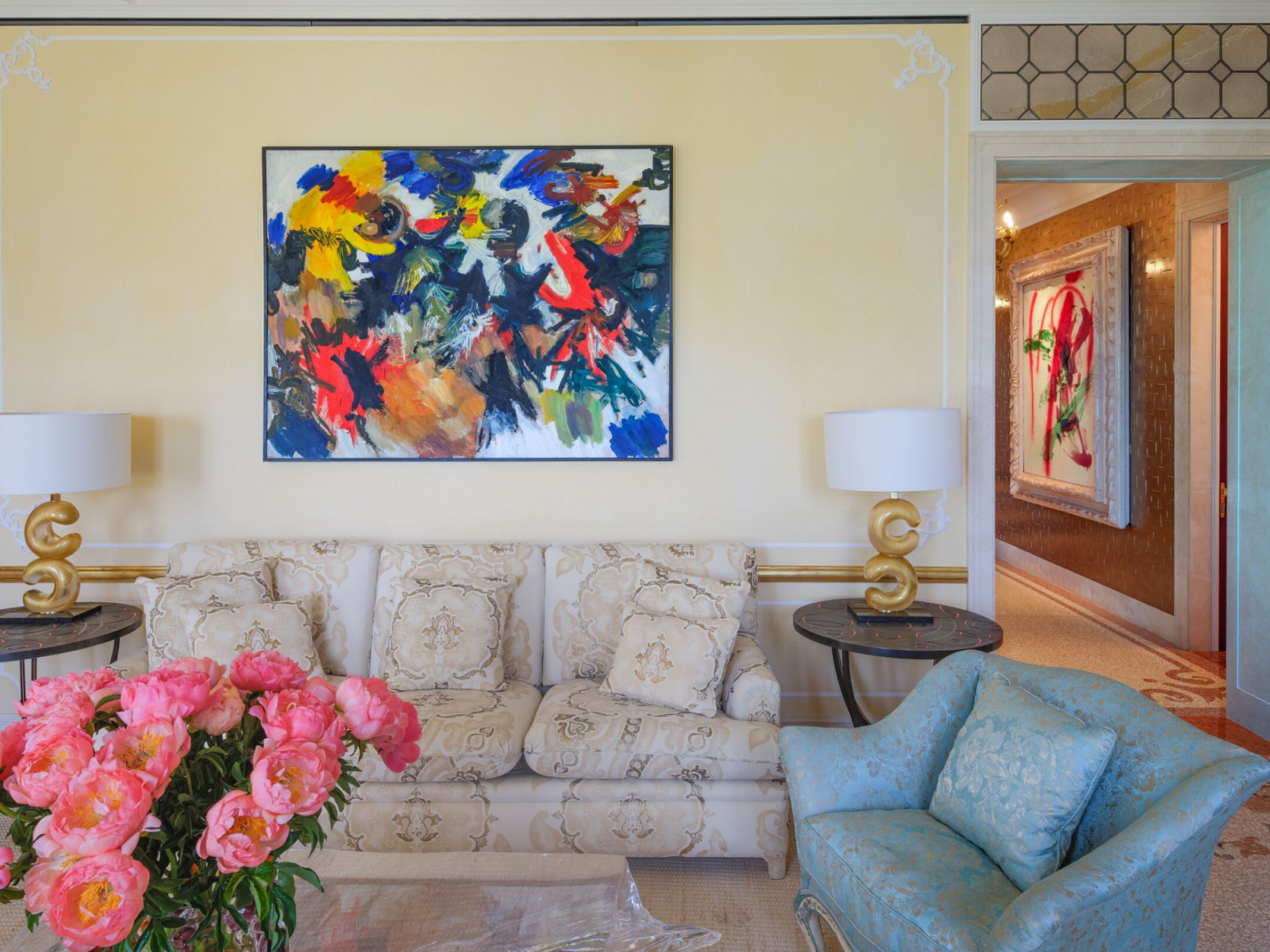 Salon featuring mid-century abstract expressionist painting above bespoke upholstery in one of the Master Suites