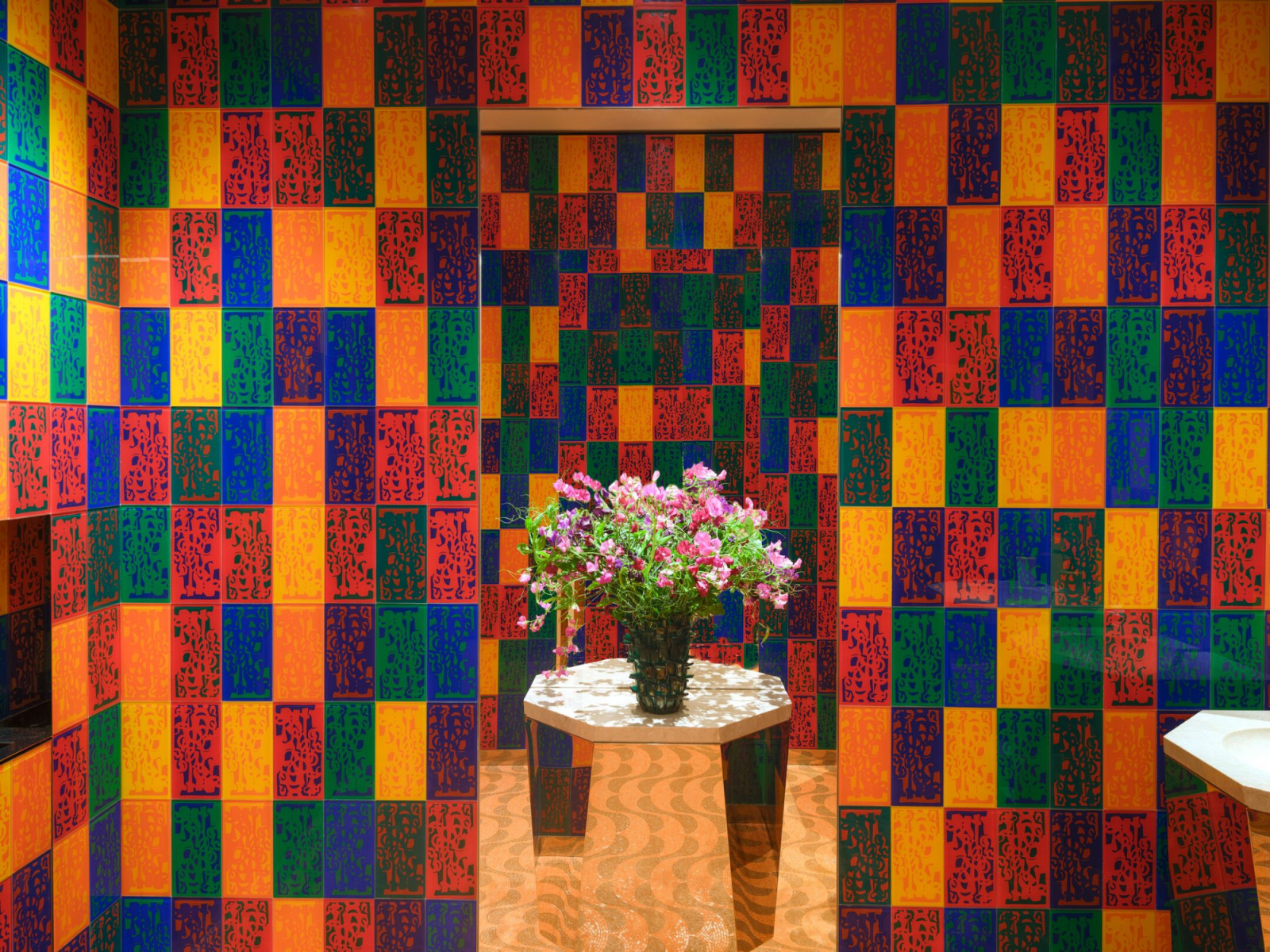 Guest bathroom featuring custom geometric tilework in vibrant colours