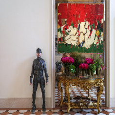 Architect Peter Marino at Hotel Cipriani, pictured with a mid-century abstract painting and gilded Venetian console in the renovated spaces