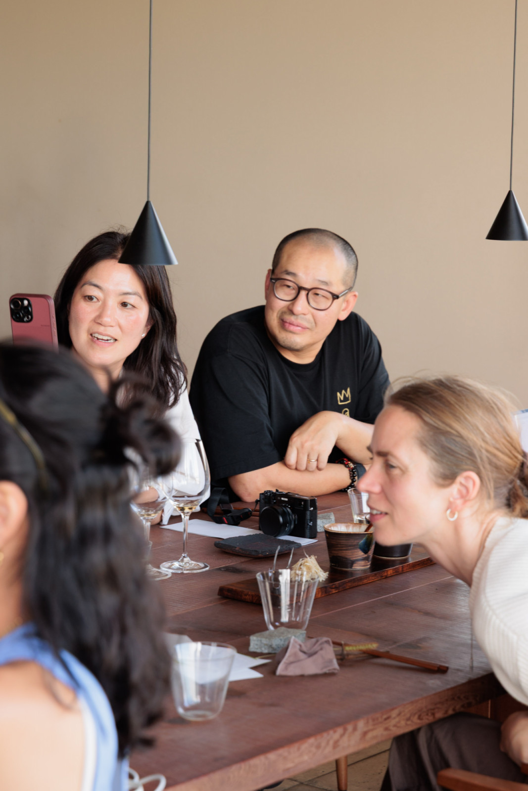 Anne Küfner, chef Mina Park and chef Kwang Uh attentively listen to the Song team as they present the next dish