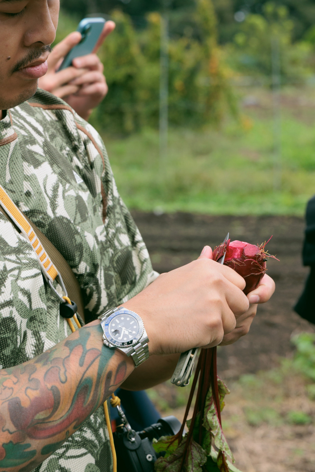 Chef Tim Flores peels a bright red beetroot we plucked from the ground at Duca Farm