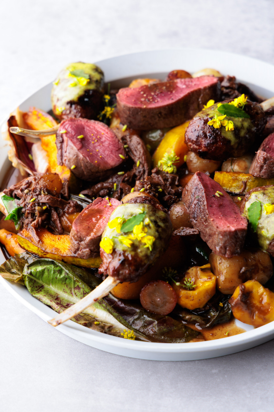 Venison rib and venison leg tsukune on a bed of local vegetables from the collaboration dinner