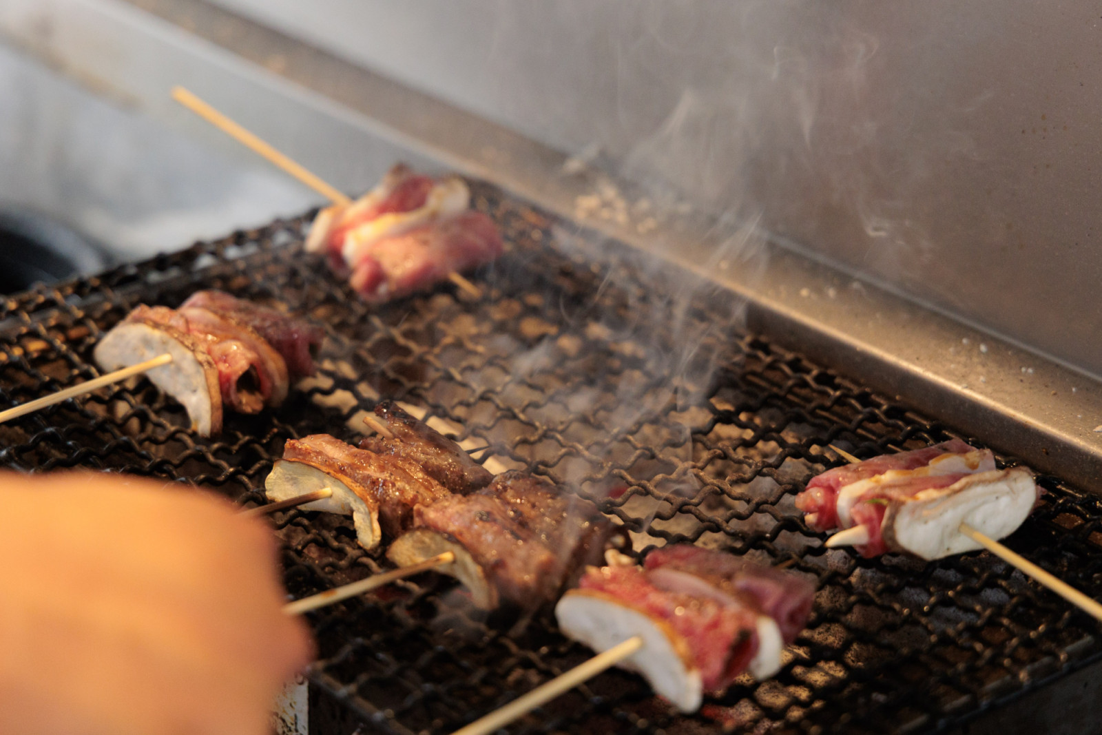 Wagyu-wrapped matsutake mushrooms grilled over charcoal