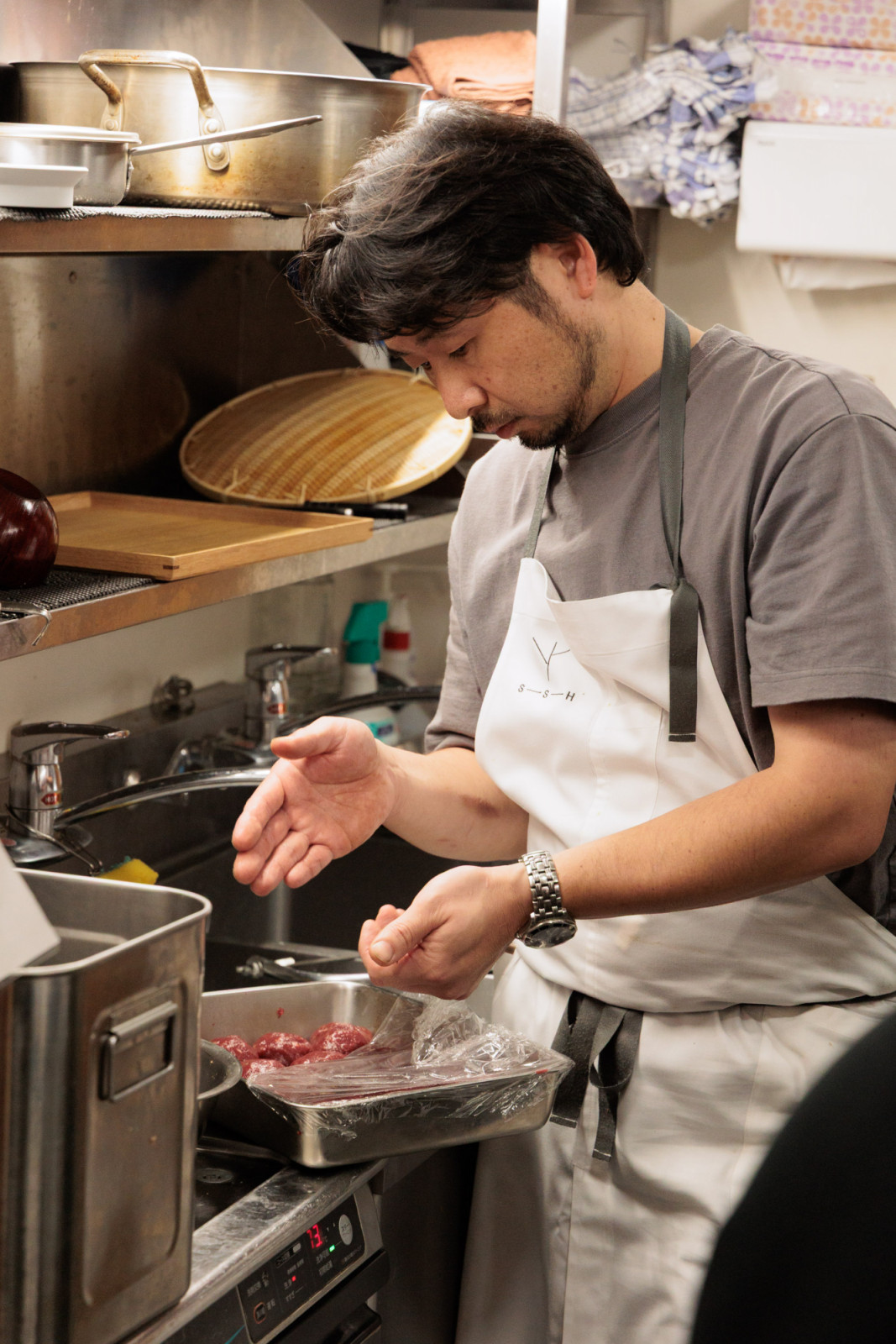 Chef Masashi Okamoto moulds his venison leg tsukune