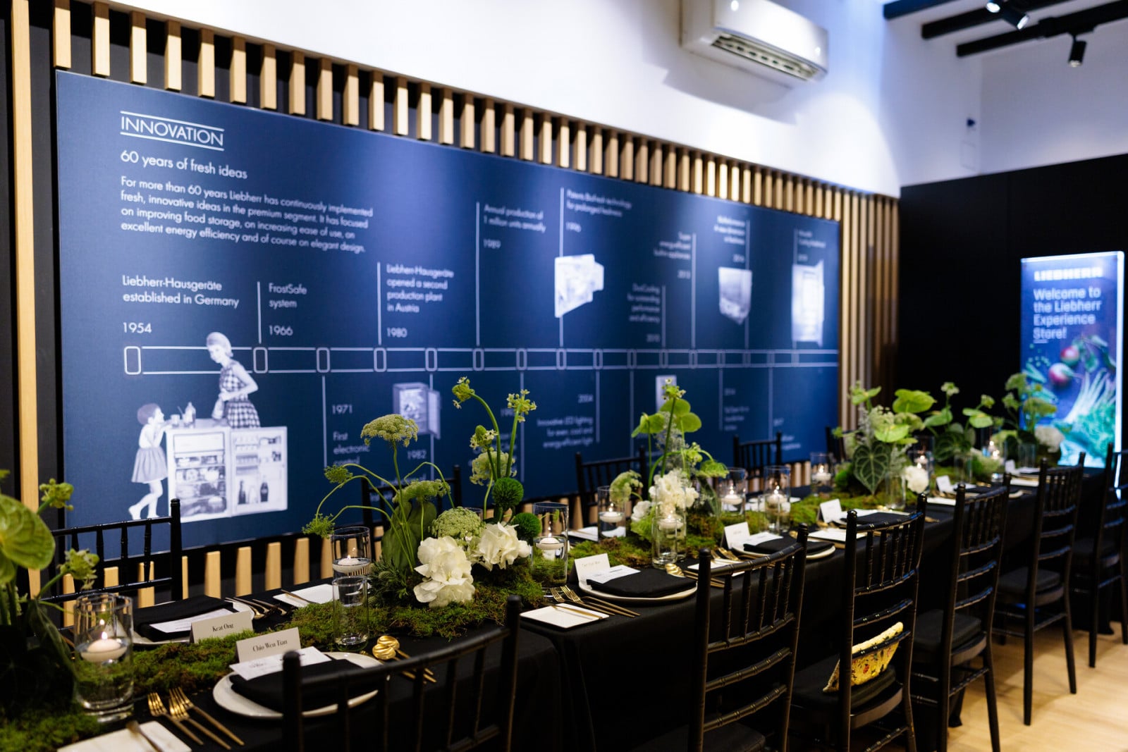 The beautiful tablescape by Fiore Dorato, set against a display of Liebherr’s history