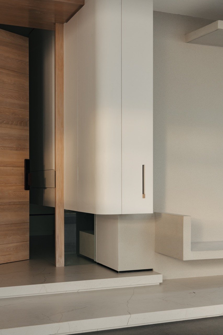 Curved cabinetry elements create visual interest while maintaining the home’s clean aesthetic