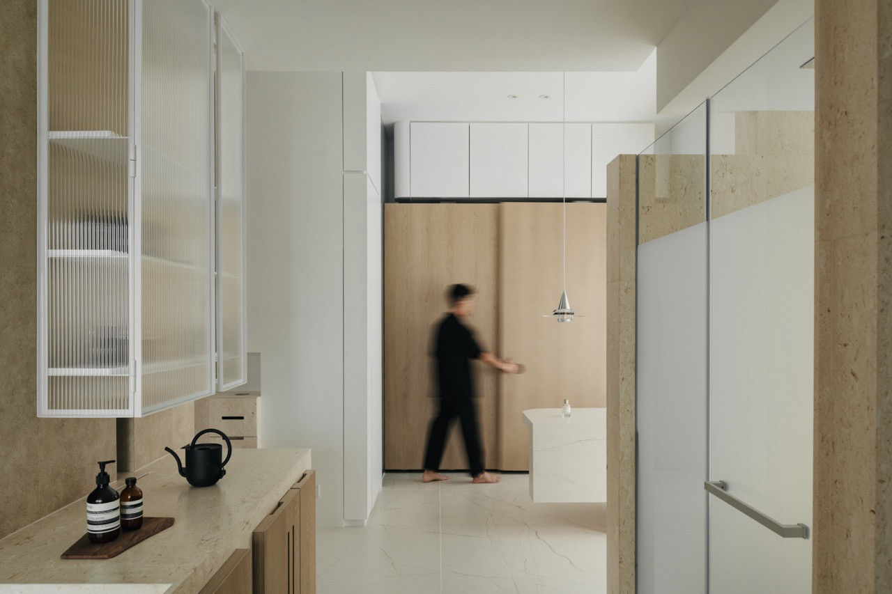 The master bathroom features a flexible sliding door system that balances privacy and openness