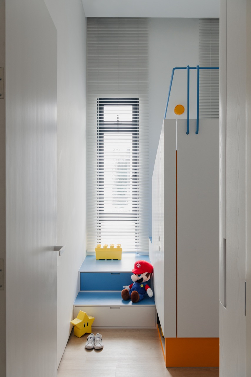 The children’s room corridor features thoughtful storage solutions that maintain a clean aesthetic.