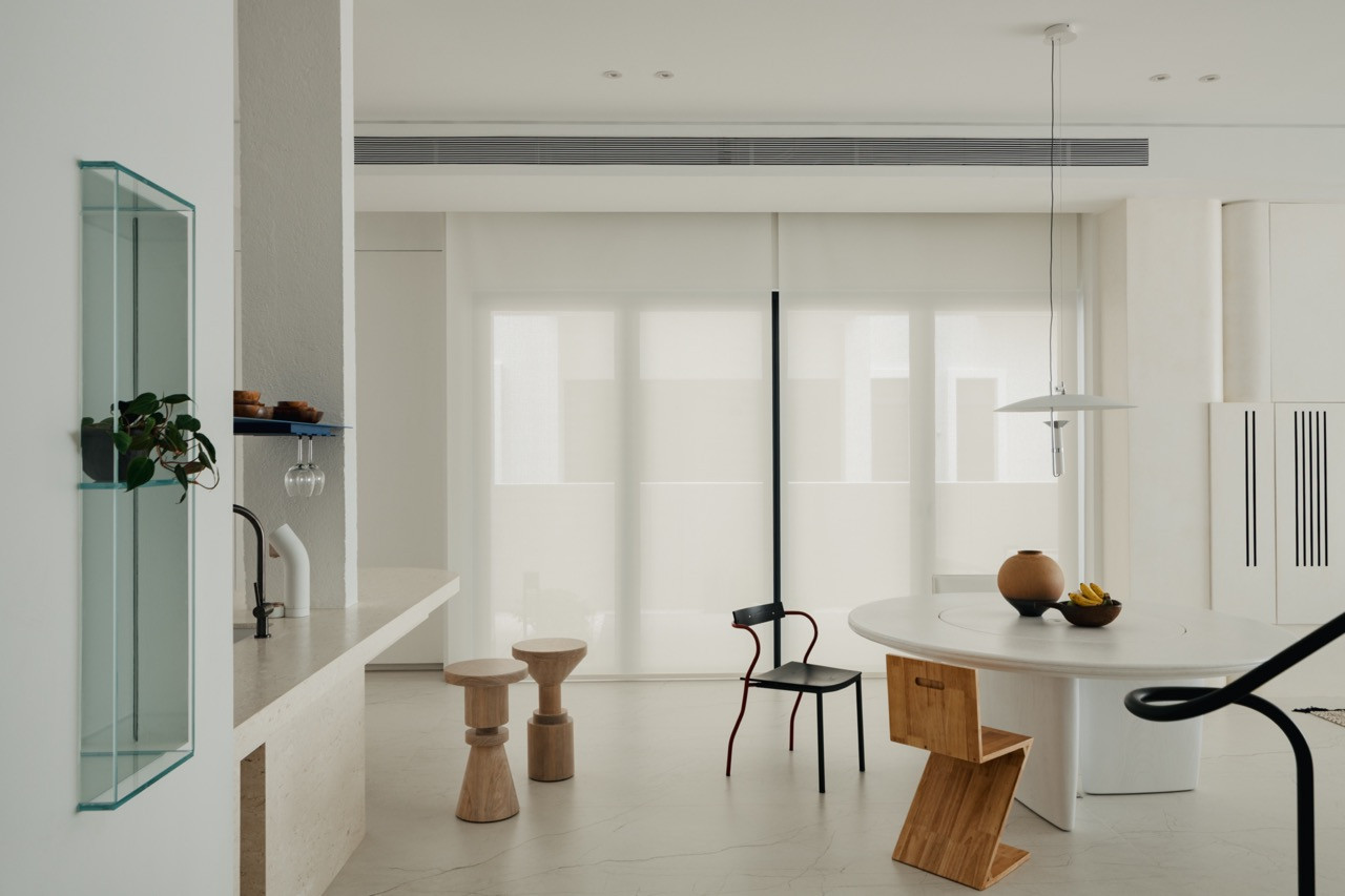 The dining area features a range of characterful seating options including the zigzagging chairs and wooden stools