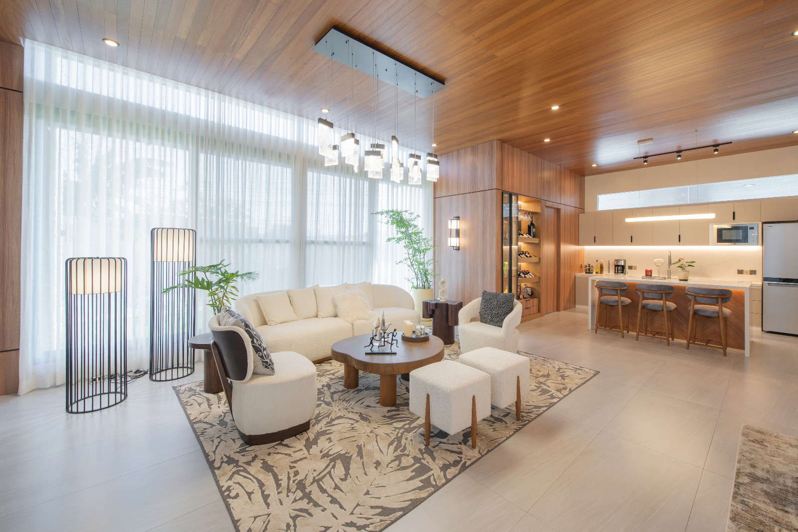The living room and kitchen area of a tropical modern bungalow in Mexico, Pampanga, designed by Innovarc