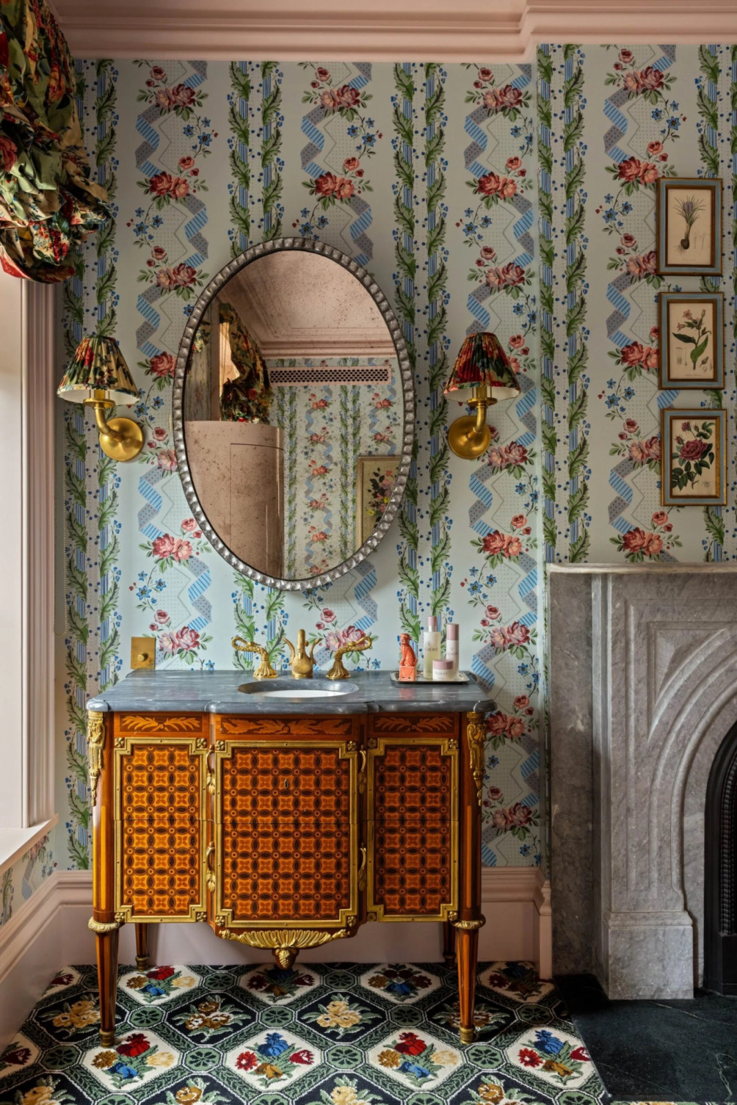 Marble-topped vanities copied from Versailles feature swan-shaped tapware and brass wall sconces (Photo: The Gambino Group)
