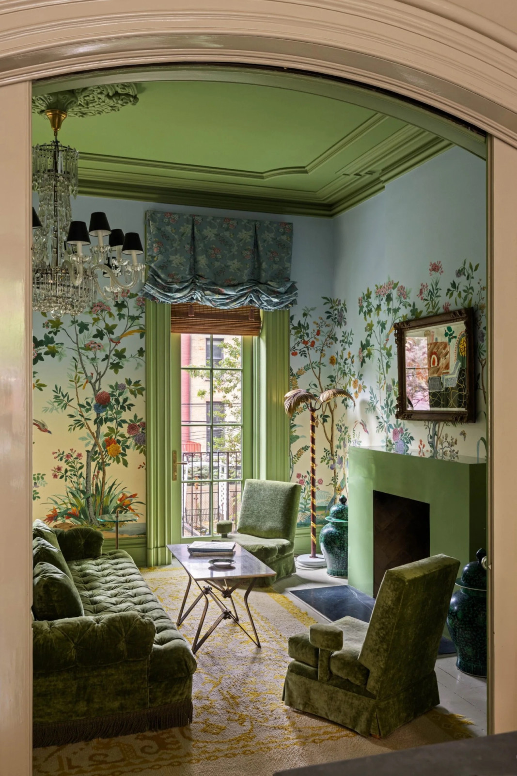 Green-painted ceiling details and wide architraves frame the garden room, which opens to the private backyard through glass doors (Photo: The Gambino Group)