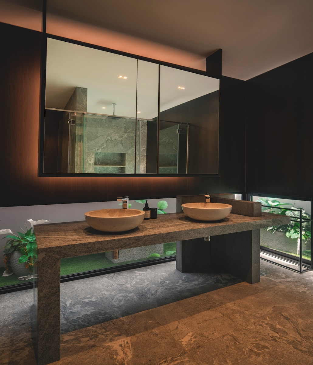 The powder room’s refined stone double sink