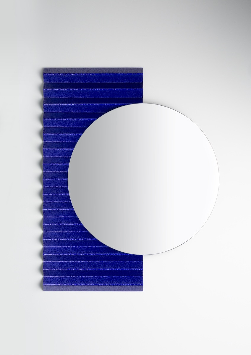 A geometric mirror featuring the same Zigzag-inspired accents in cobalt blue