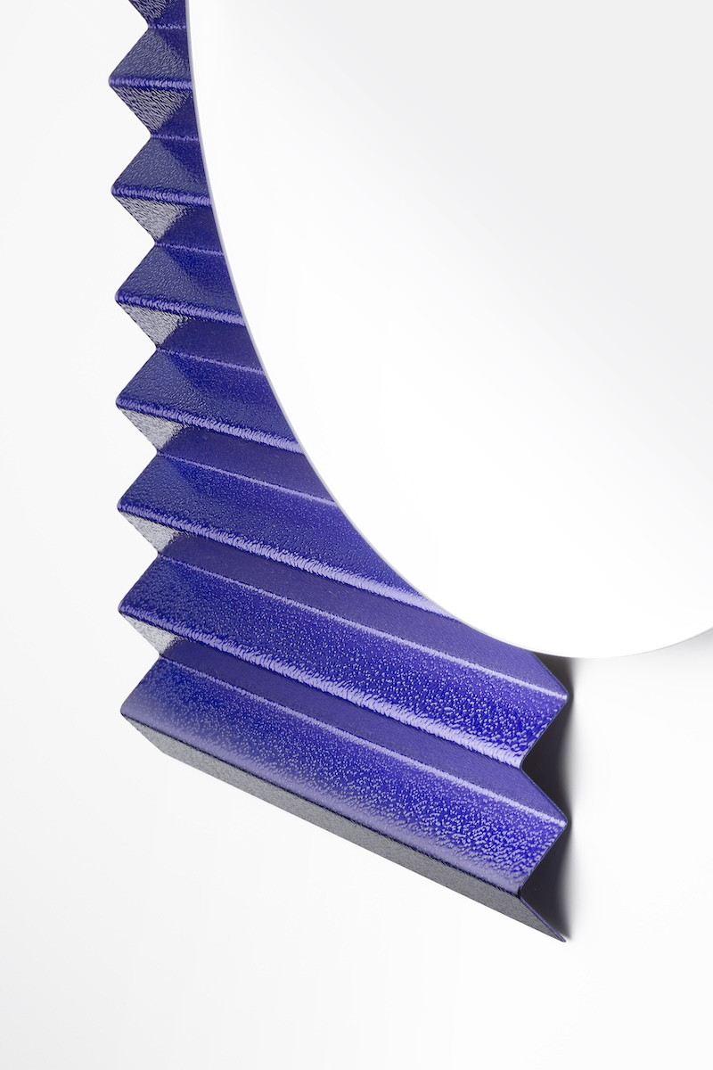 A close-up of the mirror’s cobalt blue zigzag element