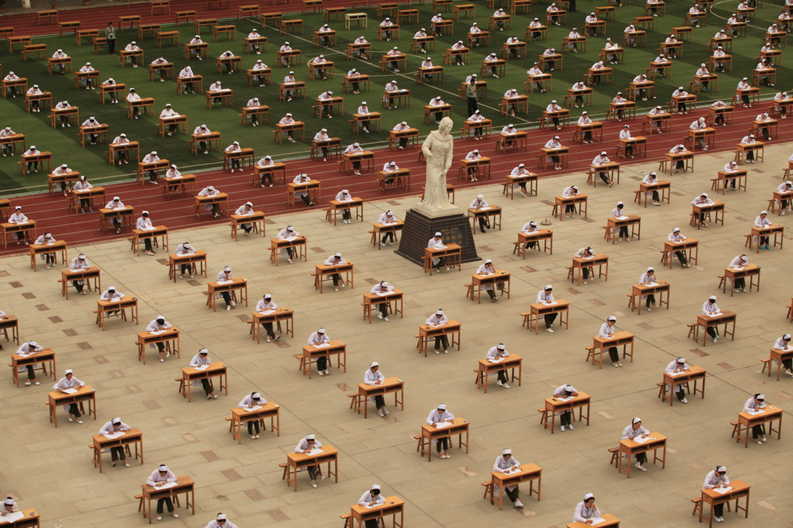 BAOJI, CHINA - MAY 25: (CHINA OUT) Students from College of Nursing in a vocational school take part in graduation examination outside classroom on May 25, 2015 in Baoji, Shaanxi province of China. Graduation examination is a matter of concerning students' future and college students of a vocational school in northwest China's Baoji in Shaanxi province conducted the test without teachers' supervision. (Photo by ChinaFotoPress/ChinaFotoPress via Getty Images)