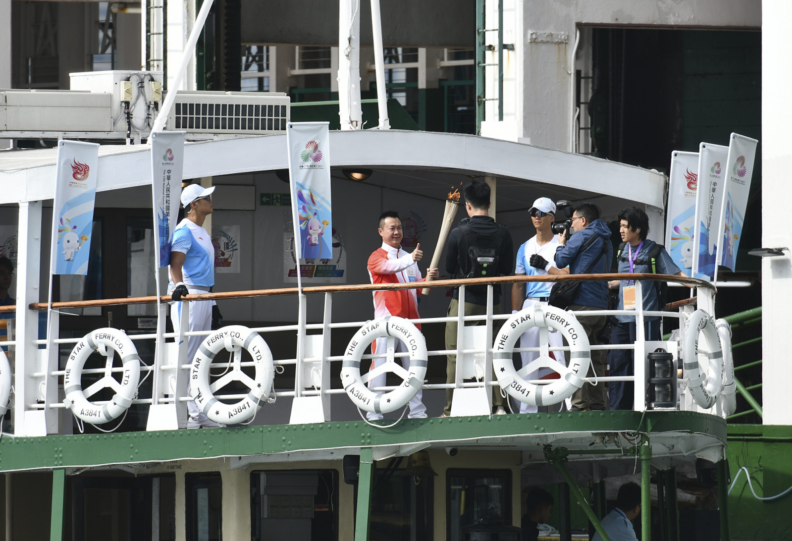 HONG KONG, CHINA - NOVEMBER 02: The torch relay for the 15th National Games of China crosses Victoria Harbour by ferry on November 2, 2025 in Hong Kong, China. The torch relay is held simultaneously in four locations: China's Hong Kong and Macao special administrative regions and the cities of Guangzhou and Shenzhen in Guangdong Province. (Photo by VCG/VCG via Getty Images)