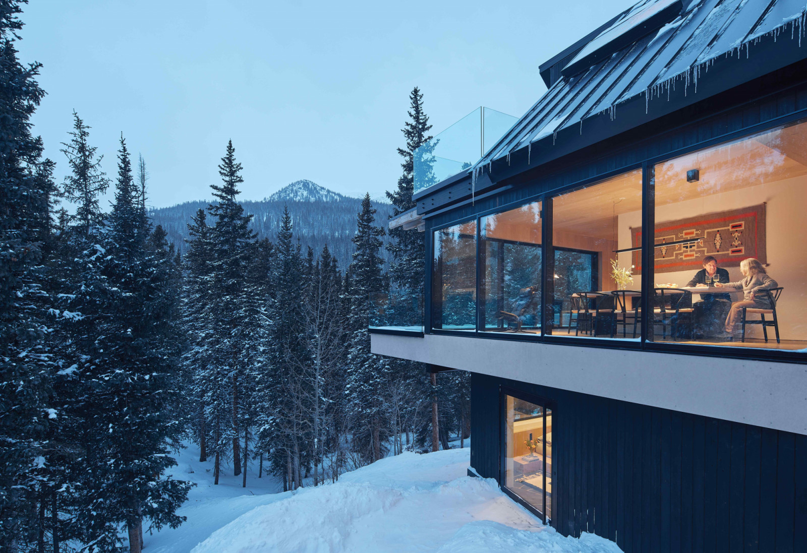 Expansive picture windows allow for passive heat gain and framed mountain views