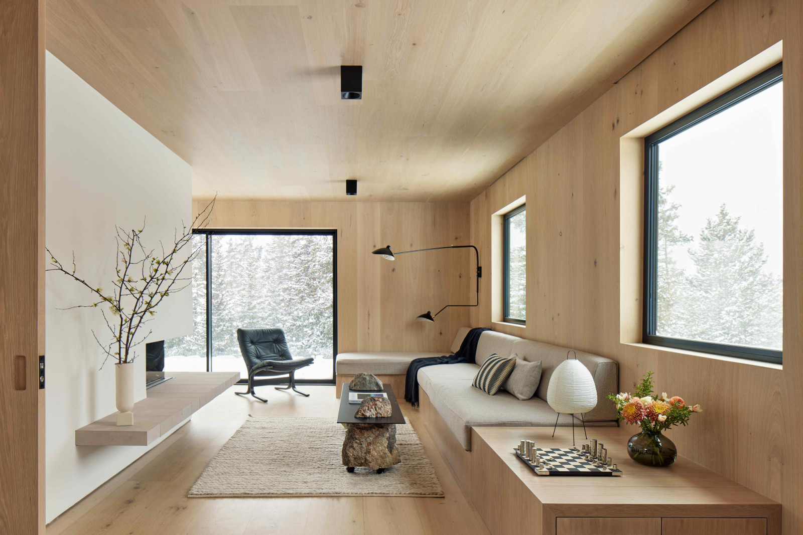 The wide-plank white oak interior creates a warm, cabin-like feel