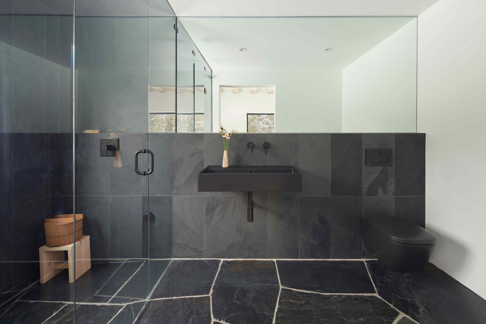 One of the bathrooms reflects the dark palette of the exterior