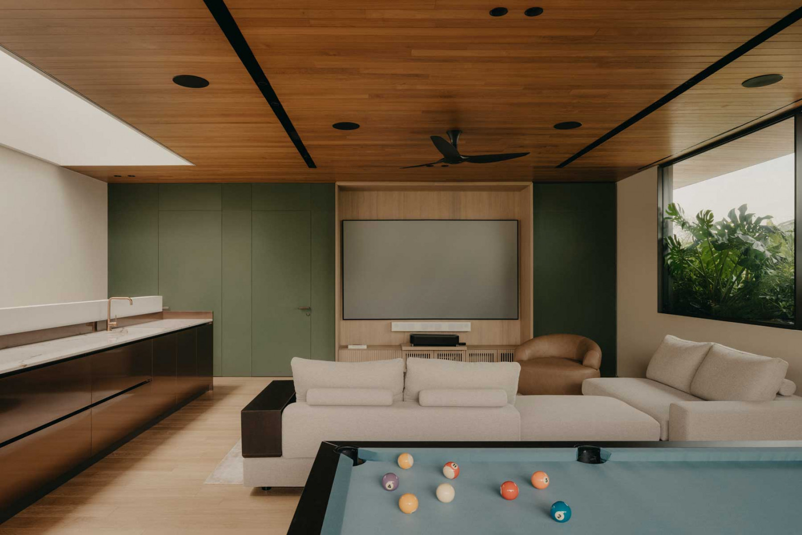 The entertainment room by 4Plus8 and Armo Design Studio is awash in natural light