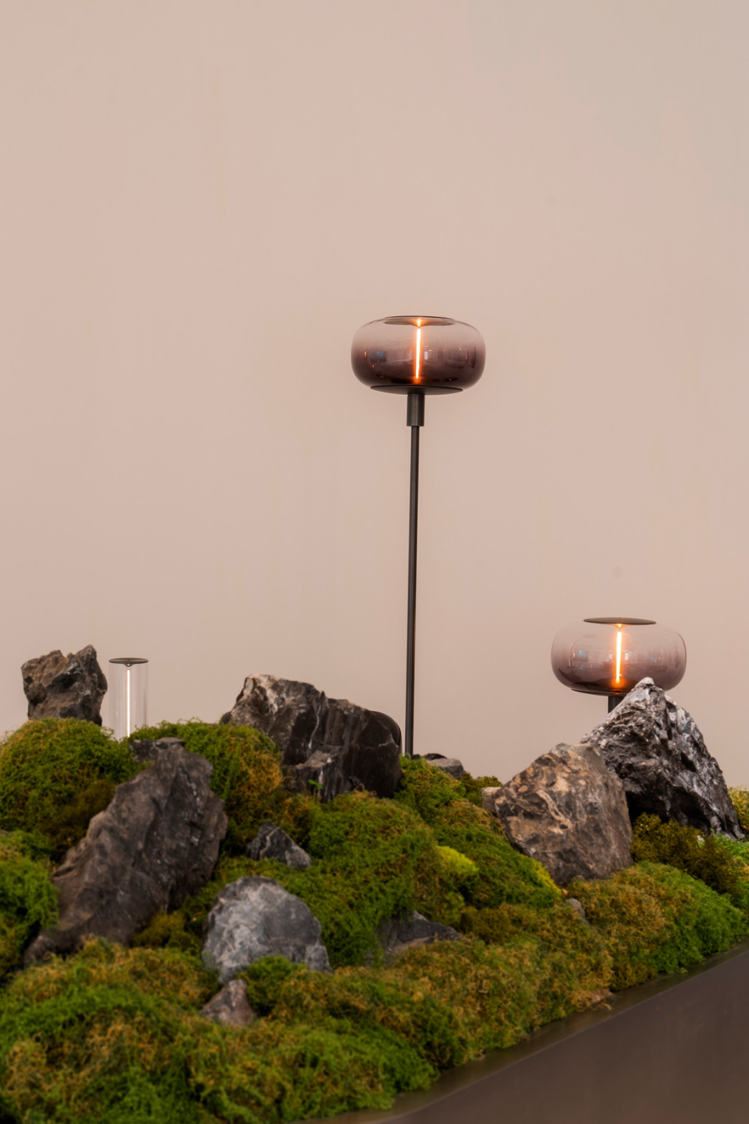 Sol Luminaire’s Magnetite lamps displayed amid a moss garden setting by Soilboy