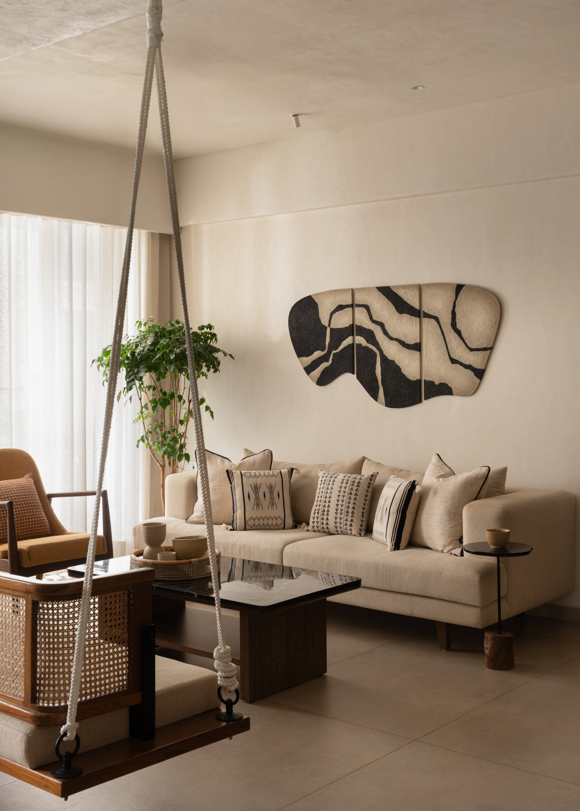 The swing centred in the living room in a Mumbai, India home by Pill Design Studio