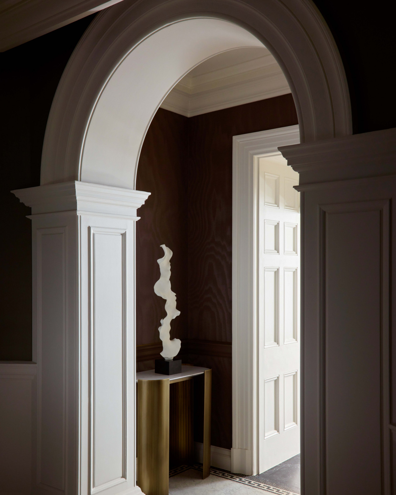 The unique details of an arched entryway in London's OWO Residences, designed by Deseesion Interiors