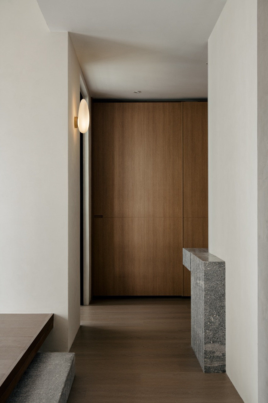 Oak storage walls define the circulation spaces throughout the 2,500-square-foot condominium