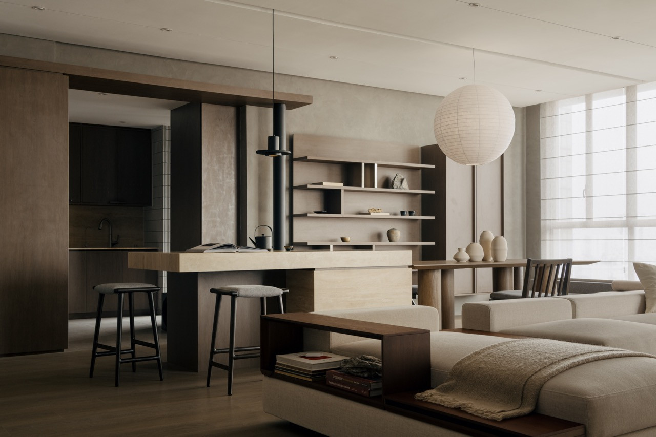 The extended living space gained from removing the balcony accommodates the kitchen island, dining table and window seating in one continuous layout