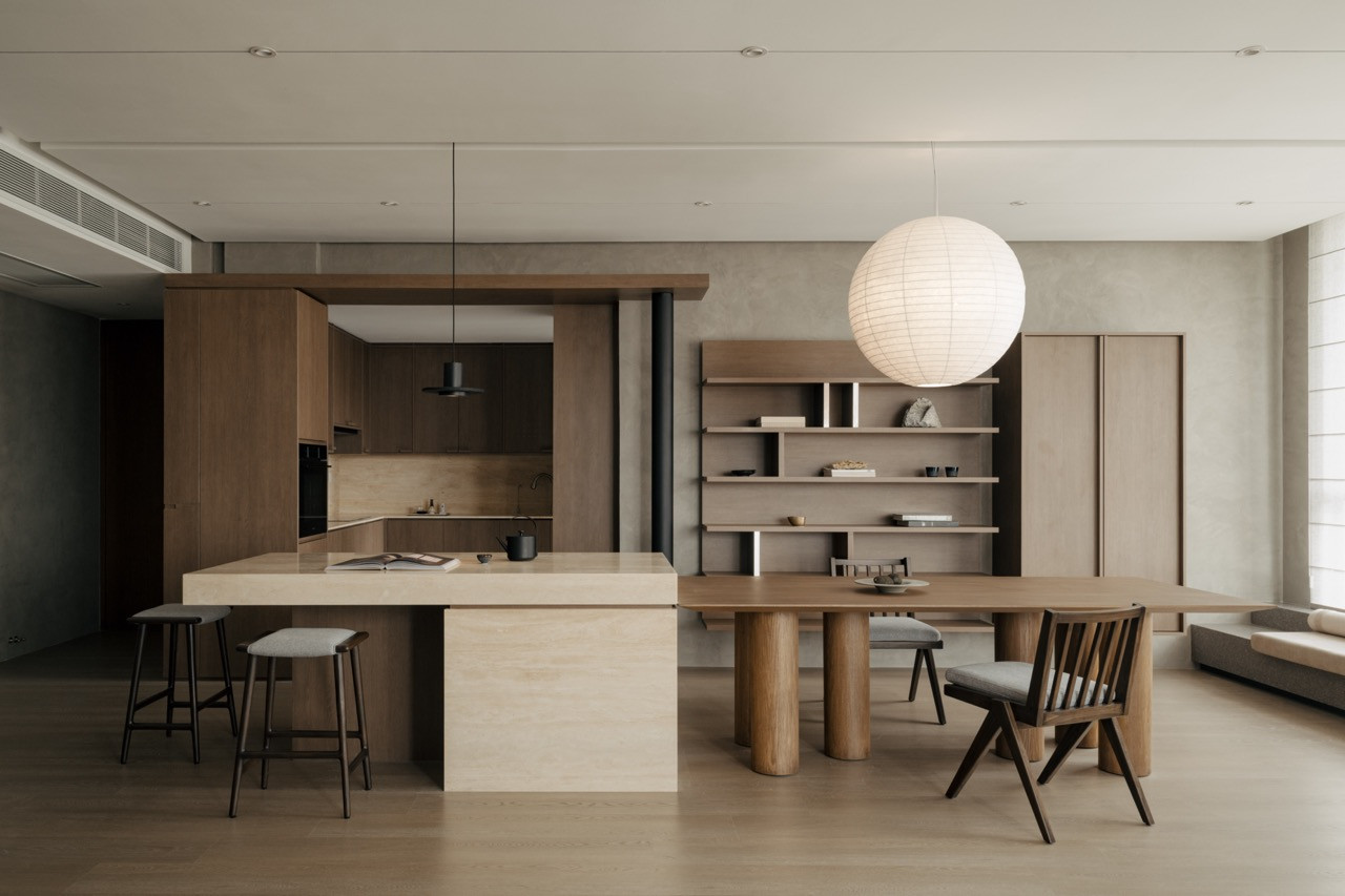 The open-plan kitchen, dining and living areas demonstrate how Tee created spatial depth within the condominium's structural constraints