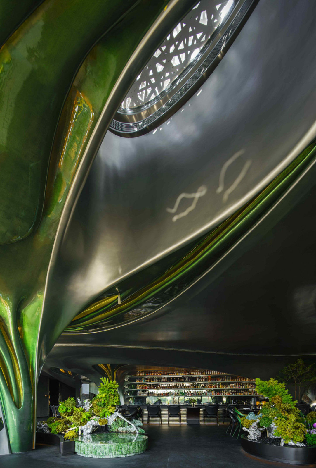 Daylight floods planted nooks peppered across the space