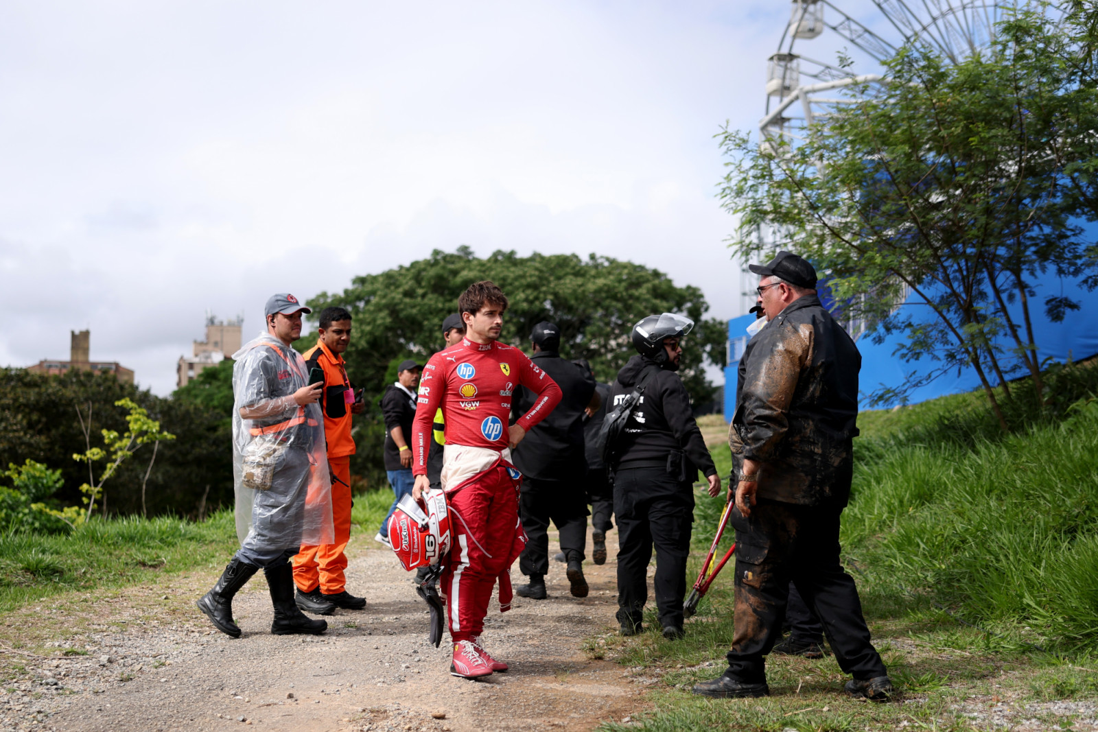 SAO PAULO, BRAZIL - NOVEMBER 09: Charles Leclerc of Monaco and Scuderia Ferrari with marshals after crashing out during the F1 Grand Prix of Brazil at Autodromo Jose Carlos Pace on November 09, 2025 in Sao Paulo, Brazil. (Photo by Lars Baron/Getty Images)