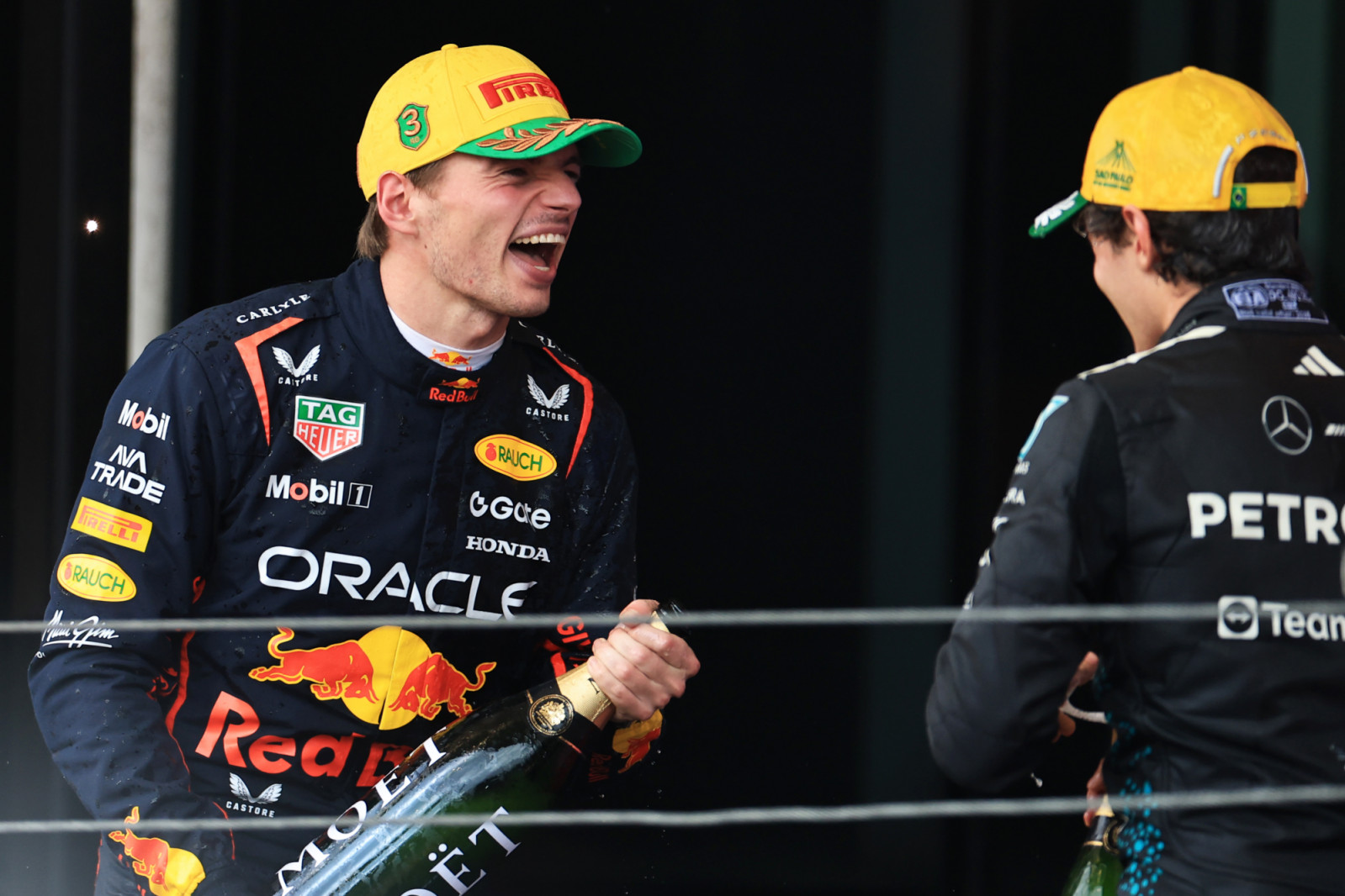 SAO PAULO, BRAZIL - NOVEMBER 09: Second placed Andrea Kimi Antonelli of Italy and Mercedes AMG Petronas F1 Team and Third placed Max Verstappen of the Netherlands and Oracle Red Bull Racing celebrate on the podium with Champagne during the F1 Grand Prix of Brazil at Autodromo Jose Carlos Pace on November 09, 2025 in Sao Paulo, Brazil. (Photo by Buda Mendes/Getty Images)