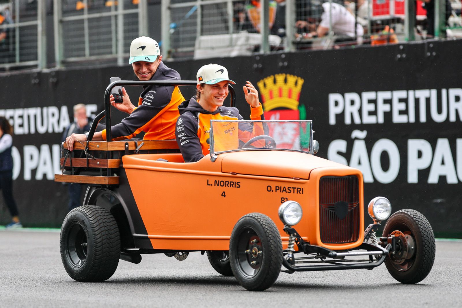 SAO PAULO, BRAZIL - NOVEMBER 9: Oscar Piastri of Australia and McLaren shares a car with Lando Norris of Great Britain and McLaren on the driver's parade during the F1 Grand Prix of Brazil at Autodromo Jose Carlos Pace on November 9, 2025 in Sao Paulo, Brazil. (Photo by Kym Illman/Getty Images)