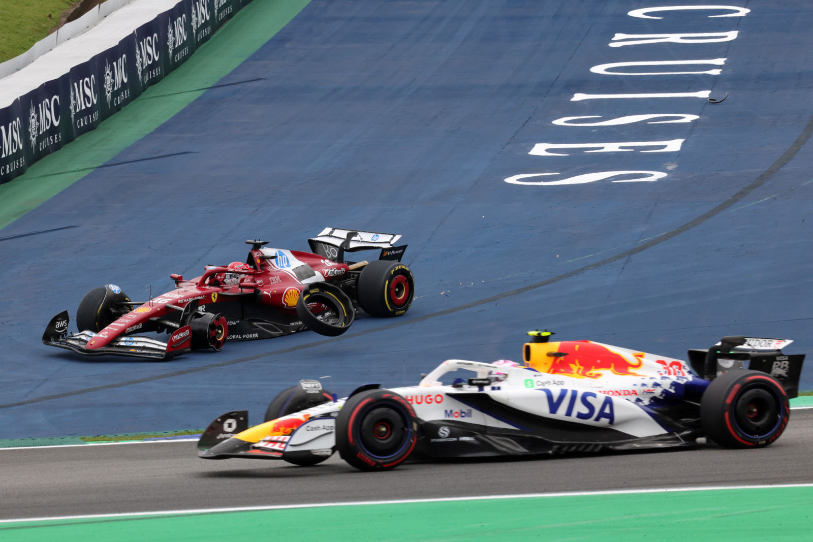 SAO PAULO, BRAZIL - NOVEMBER 09: Liam Lawson of New Zealand driving the (30) Visa Cash App Racing Bulls VCARB 02 passes on track as Charles Leclerc of Monaco driving the (16) Scuderia Ferrari SF-25 crashes out at the restart during the F1 Grand Prix of Brazil at Autodromo Jose Carlos Pace on November 09, 2025 in Sao Paulo, Brazil. (Photo by Anni Graf - Formula 1/Formula 1 via Getty Images)