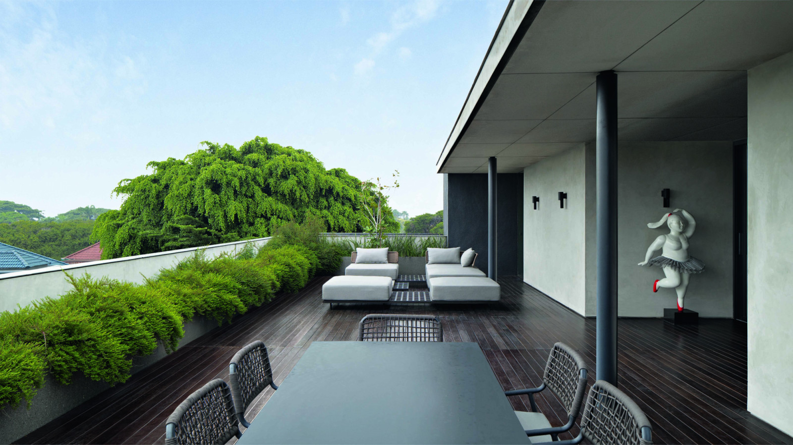 The generous rooftop deck features oversized outdoor furniture and a ballerina sculpture by the lady of the house herself