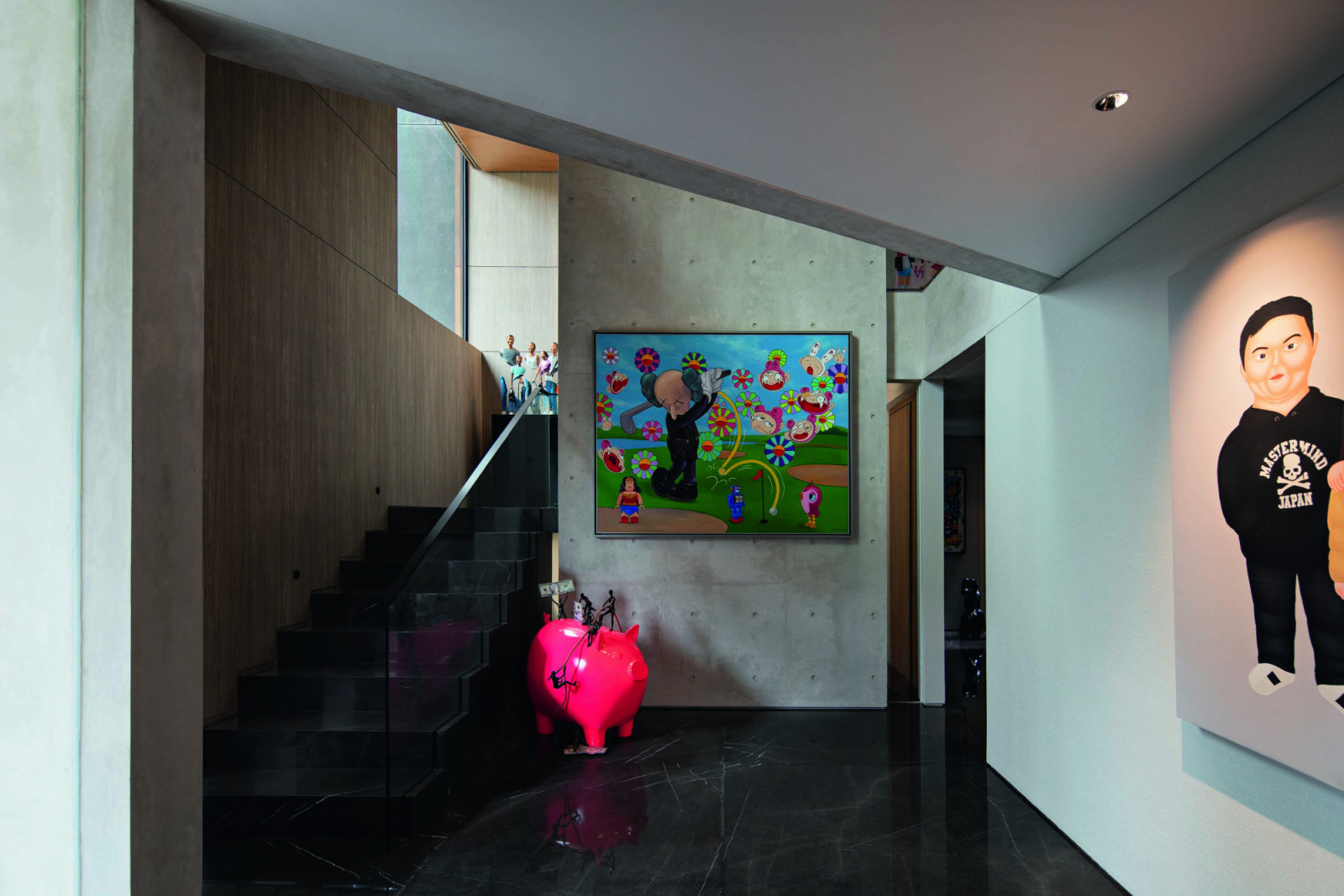 Artworks with cheerful colours complement the subdued material palette on the Pondok Indah home’s ground floor