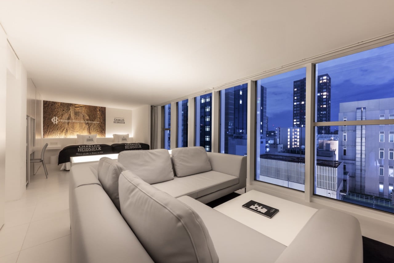A suite at Cuvee J2 Hotel Osaka features floor-to-ceiling windows framing views across the Osaka Shinsaibashi district.