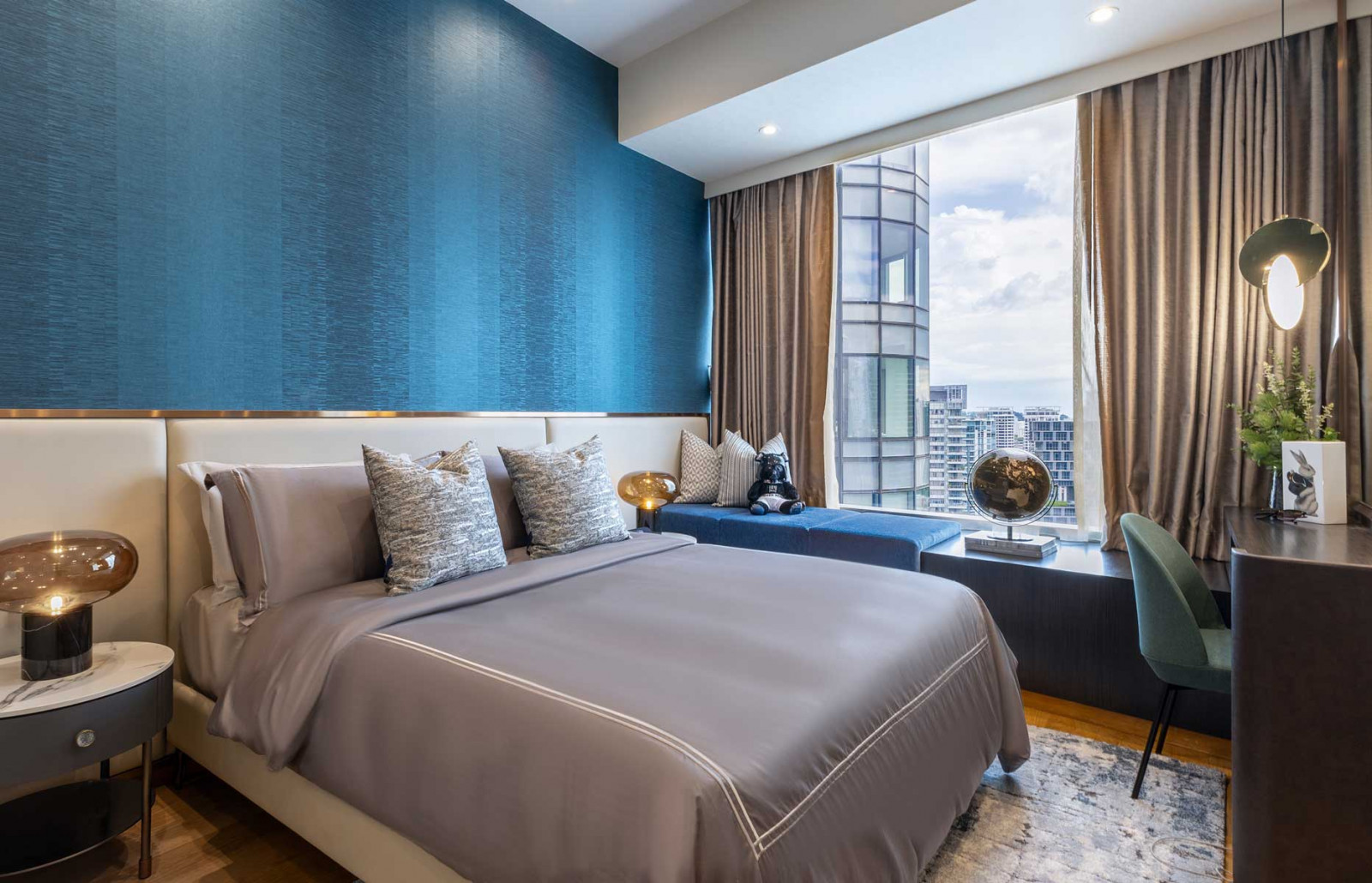 Blue accents and a bay window impart a refreshing touch that frames the vistas here