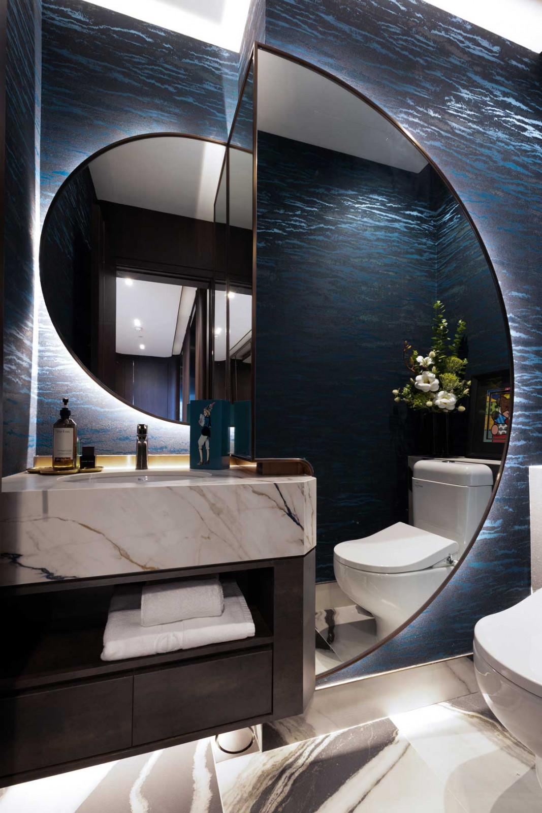 Half-moon mirrors in this bathroom corner introduce a playful optical effect